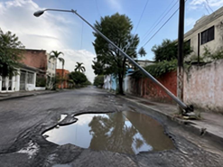 Calle con un bache lleno de agua
